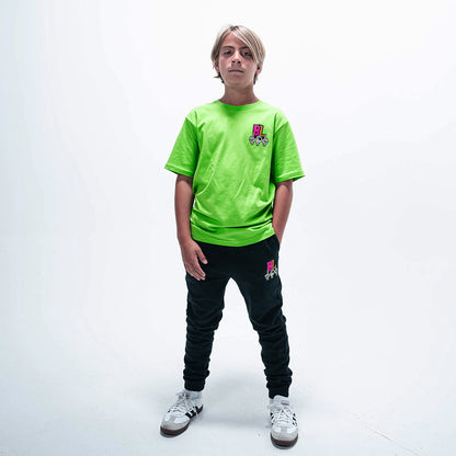 Youth model wearing green youth graphic tee with "101 Skeleton" design