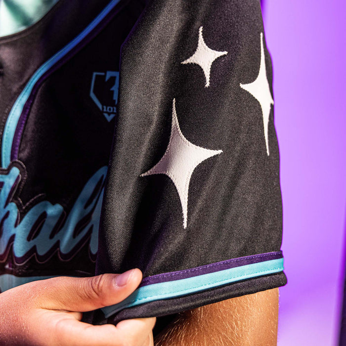 Close-up of a black sports jersey with star designs and BL101 logo on a purple background.