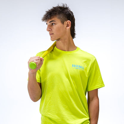 Person wearing a bright yellow t-shirt with 'BASEBALL Lifestyle 101' text, holding a green bat against a white background