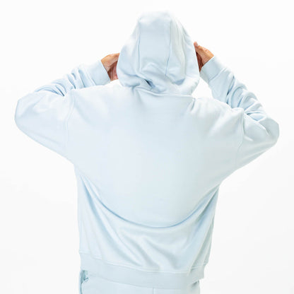 Youth model wearing Blue Baseline hoodie