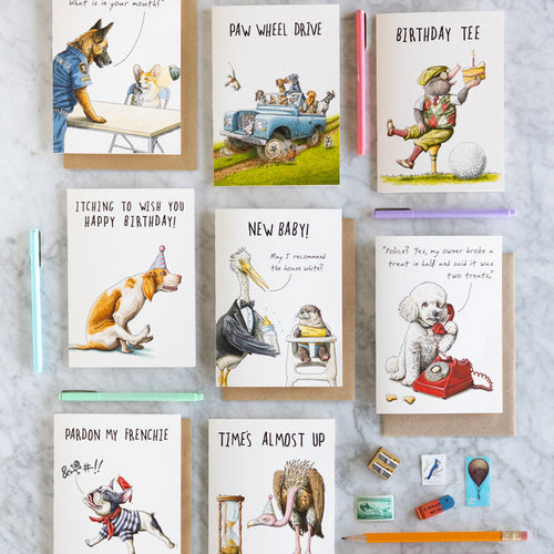 Collection of Bewilderbeest greeting cards with various designs on a gray surface.