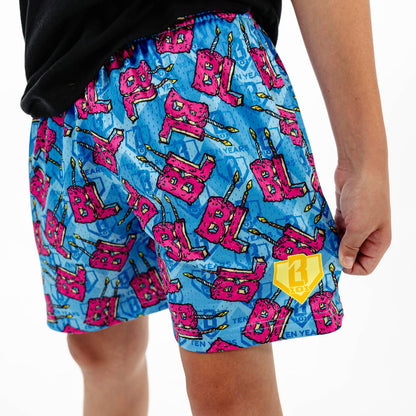 Youth model wearing blue youth shorts with "BL Birthday" design