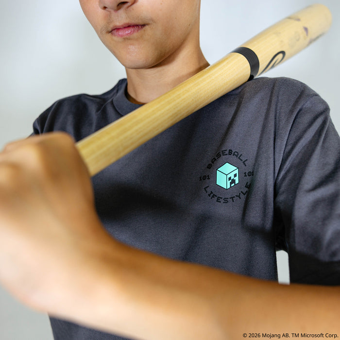 Youth model wearing gray youth graphic tee with "BL101 X Minecraft Athletics" design