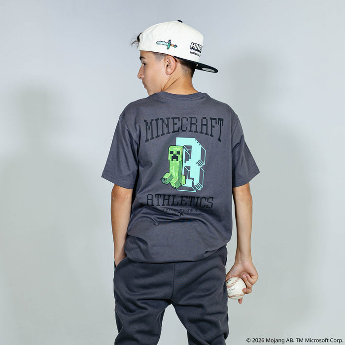 Youth model wearing gray youth graphic tee with "BL101 X Minecraft Athletics" design