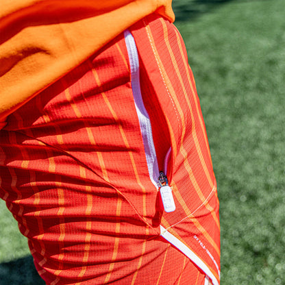 Adult model wearing orange Diamond Tech with Liner Orange Gradient shorts