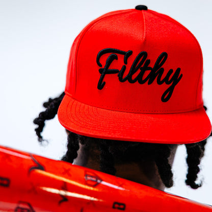 Adult model wearing red and black Filthy Off Field Snapback hat