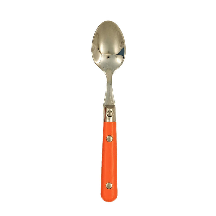 Spoon with an orange handle on a white background.