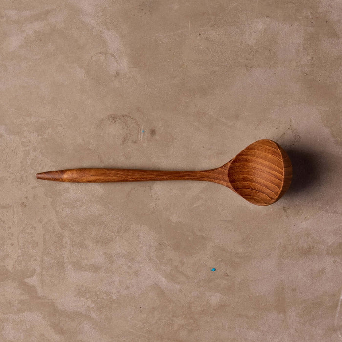 Teak sauce ladle on table