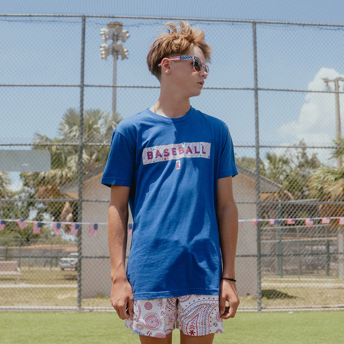 Youth model wearing blue Paisley Liberty youth graphic tee
