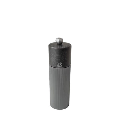 Gray pepper grinder with grey wooden top and metal body with Peugeot logo