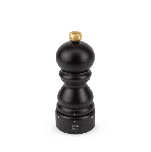 Dark brown pepper grinder with gold top on a whitet background