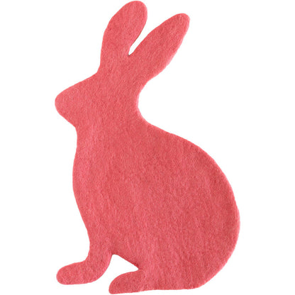 A pink bunny-shaped felt placemat against a white background.