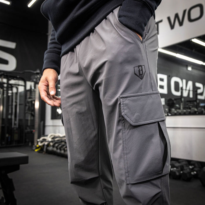 Youth model wearing gray Pro Series Long Cuff Cargo Performance youth joggers