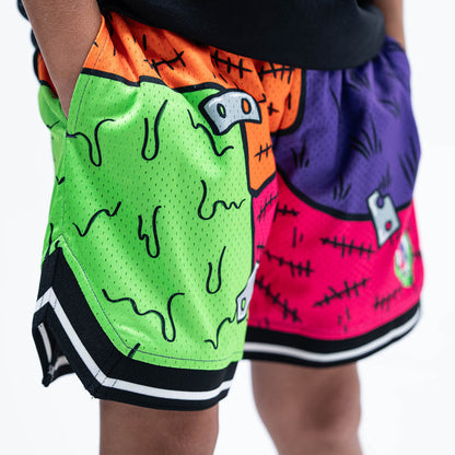 Youth model wearing multi-color youth shorts with "Stitched For The Show" design